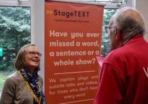 Stagetext Outreach Co-ordinator Christine speaks to a volunteer at Hearing Help Essex